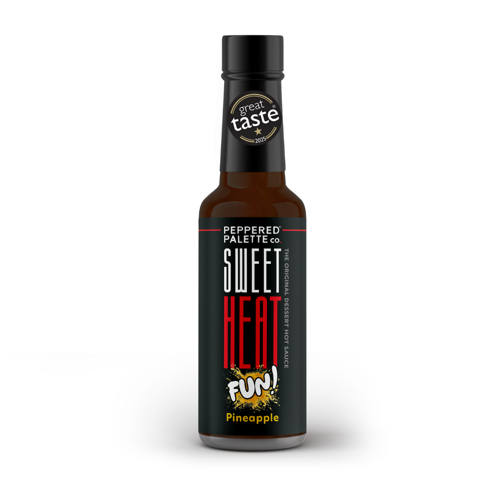 Bottle of 'Sweet Heat Fun!' pineapple hot sauce with a black label and a Great Taste 2025 gold star logo