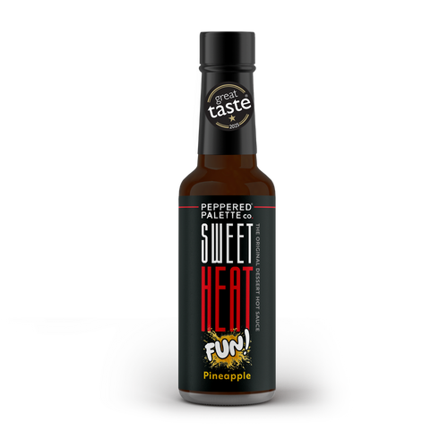 Bottle of 'Sweet Heat Fun!' pineapple hot sauce with a black label and a Great Taste 2025 gold star logo